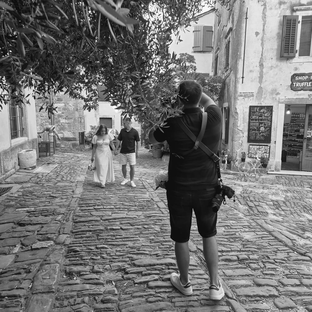 Igor Obradović photographing a couple on a cobbled old-town street